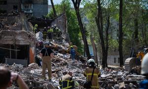 Rescue workers dig through the rubble of a bombed building in Kyiv, Ukraine.