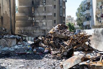 A pile of rubble and a burnt-out car in front of a damaged residential building in Beirut, Lebanon. James Elder is visiting the site.