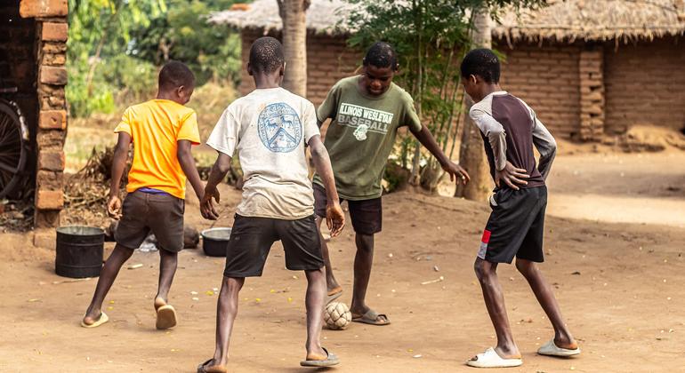 Bernard Daud (in green tshirt) playing football with his friends at Alesi Mitambo's compound in Chabwera Village, Chiradzulu district