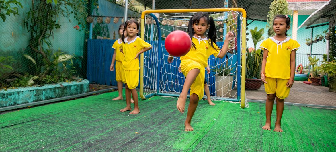 Young girls play football at school in Soc Trang Province, Viet Nam. Young girls play football at school in Soc Trang Province, Viet Nam.