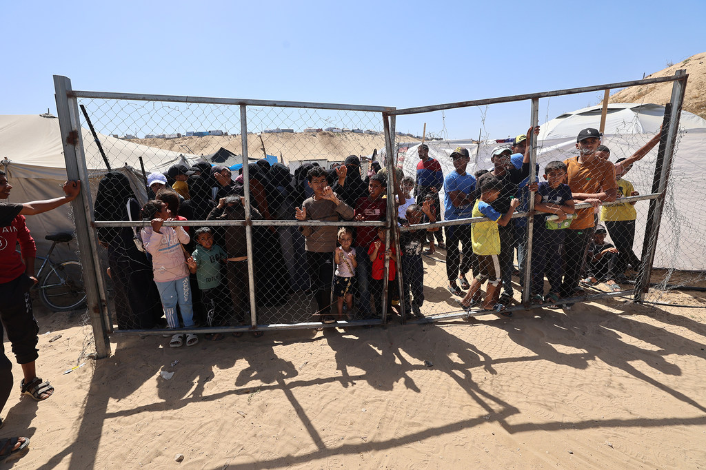 Children wait at a UN-supported malnutrition treatment centre in Khan Younis, southern Gaza.