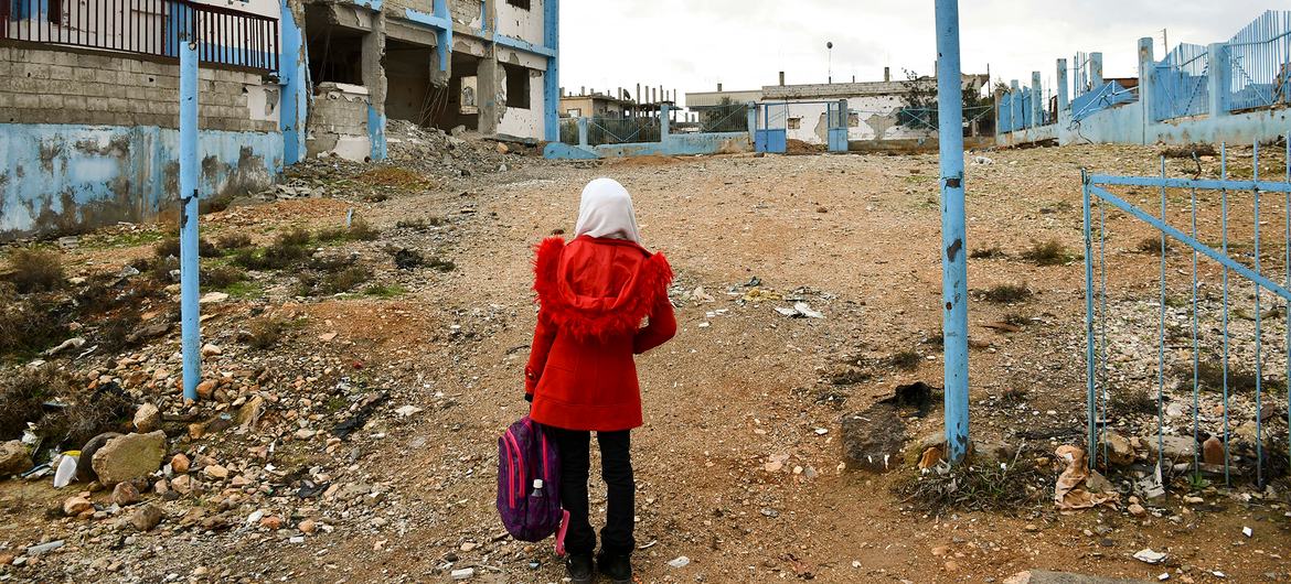 A girl walks through a destroyed school in Dara’a Albalad, in southern Syria. (file)