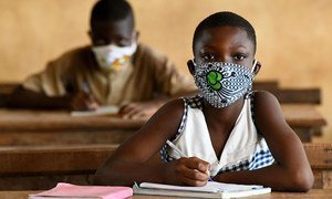 Children in Côte d'Ivoire wear face masks as they return to school after temporary closures due to COVID-19.