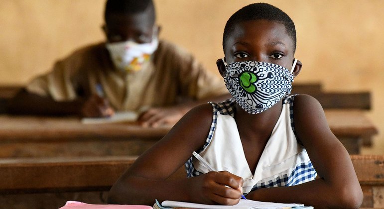 Children in Côte d'Ivoire wear face masks as they return to school after temporary closures due to COVID-19.