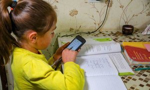A seven-year-old girl studies at home during school closures in Georgia caused by the COVID-19 pandemic.