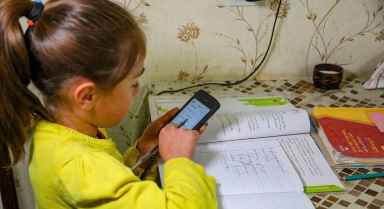 A seven-year-old girl studies at home during school closures in Georgia caused by the COVID-19 pandemic.