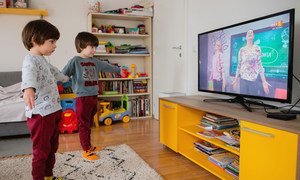 Twin brothers in North Macedonia practice yoga for children as they follow a TV-classroom programme broadcast on national television.
