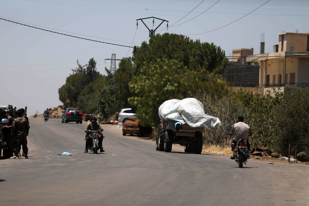 People pass through the streets of a town in As-Sweida governorate.