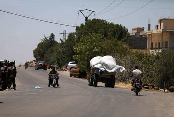People pass through the streets of a town in As-Sweida governorate.