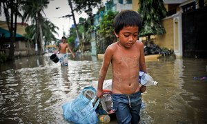 A boy drags possessions through the flooded streets of Manila in the aftermath of a typhoon. (file)