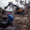 Workers clear debris following a bombing in Irpin, Ukraine. (file)