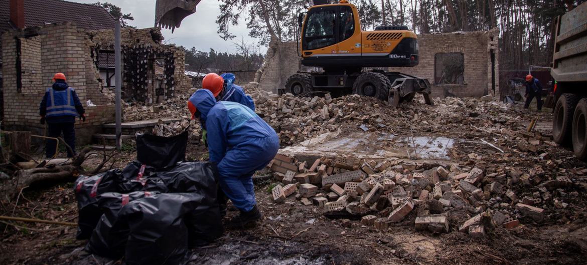 Workers clear debris following a bombing in Irpin, Ukraine. (file)