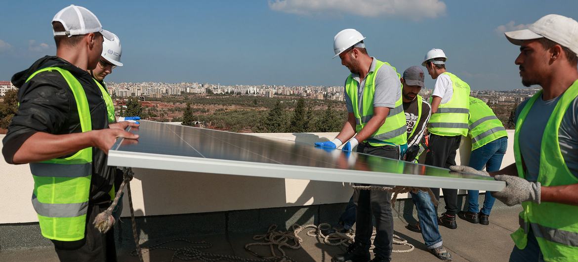 Workers install solar panels in Beirut, Lebanon.