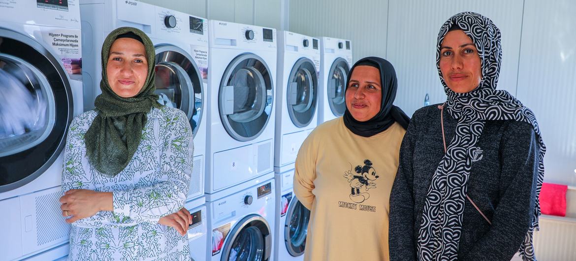 Vefa, Neslihan and Emel (left to right) at work at the laundromat.