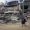 غزہ کے علاقے خان یونس میں ملبے کا ڈھیر بنی رہائشی عمارتوں کے پاس سے گزرتا ہوا ایک بچہ۔