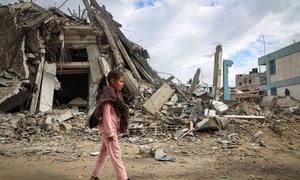 A young girl walks through destroyed streets in Khan Younis, in the southern Gaza Strip.