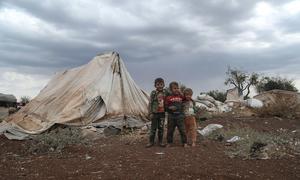 من الأرشيف: أطفال صغار نزحوا بسبب النزاع في سوريا يقفون أمام أحد الملاجئ.