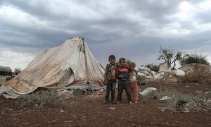 Young boys displaced by conflict in Syria stand in front of a shelter. (file)