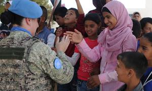A peacekeeper greets the students of the Faouar School in Syria which was one of the four schools that was refurbished by the UN Disengagement Force.