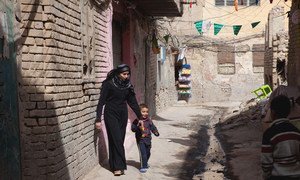 A woman and her son walk in the Futhal neighbourhood of Baghdad in Iraq.