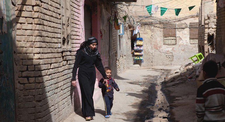 A woman and her son walk in the Futhal neighbourhood of Baghdad in Iraq.