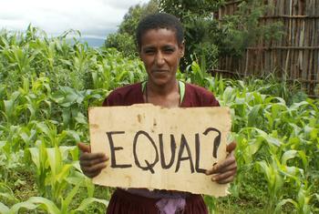 A single word, ‘Equal?’ – the stark question behind Africa’s demand for UN reform. Pictured: an Ethiopian woman farmer holding a sign.