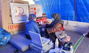 A mobile health team from UNFPA provides reproductive health services to displaced women and girls in a temporary shelter in northern Syria, offering dignity kits and psychosocial counselling.