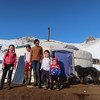 Children from a herding family in rural Mongolia line up outside their yurt.