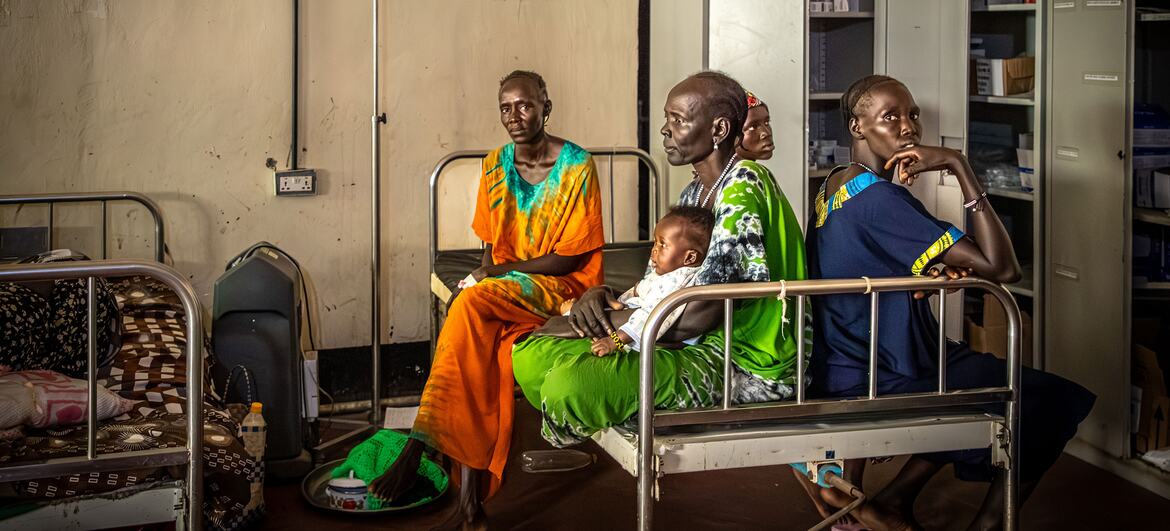 Women and children sit in hospital beds at Akobo County Hospital in Jonglei State, South Sudan, on February 21, 2026. The hospital, managed by the government, is lacking medicine and resources and treats many civilians for gunshot wounds and burns.
