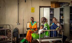 Women and children sit in hospital beds at Akobo County Hospital in Jonglei State, South Sudan, on February 21, 2026. The hospital, managed by the government, is lacking medicine and resources and treats many civilians for gunshot wounds and burns.