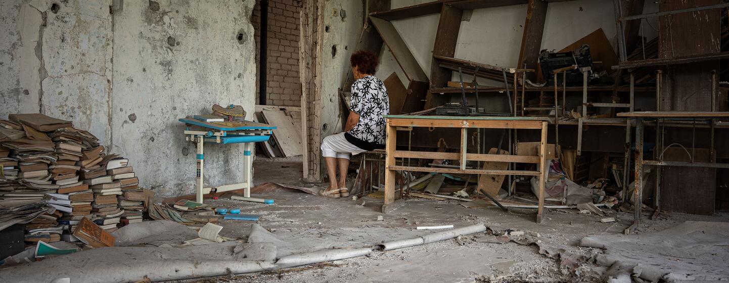 Maryna sits in a destroyed school classroom in Kherson where she used to teach Ukrainian literature.