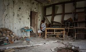 Maryna sits in a destroyed school classroom in Kherson where she used to teach Ukrainian literature.