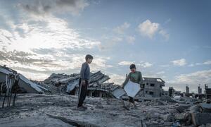 Two Palestinian children, Yazan (10) and Ali Muhammad (7), play on the debris of their destroyed home in Al-Zarqaa, Gaza City, after returning from displacement due to war, now living in a tent and relying on WFP assistance.