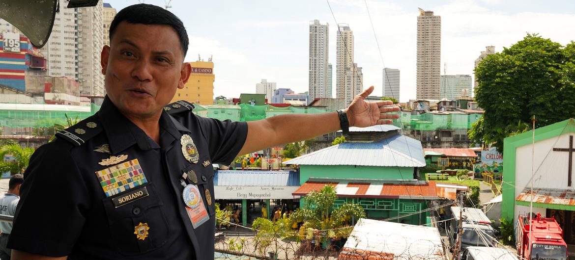 Warden Lino Montano Soriano gestures across the Manila City Jail compound.
