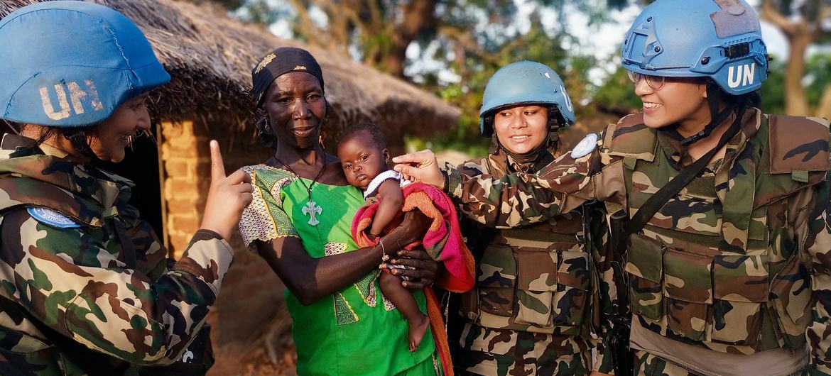 Women UN peacekeepers interact with a woman and baby in the Central African Republic.