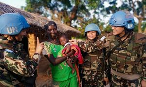Women UN peacekeepers interact with a woman and baby in the Central African Republic.