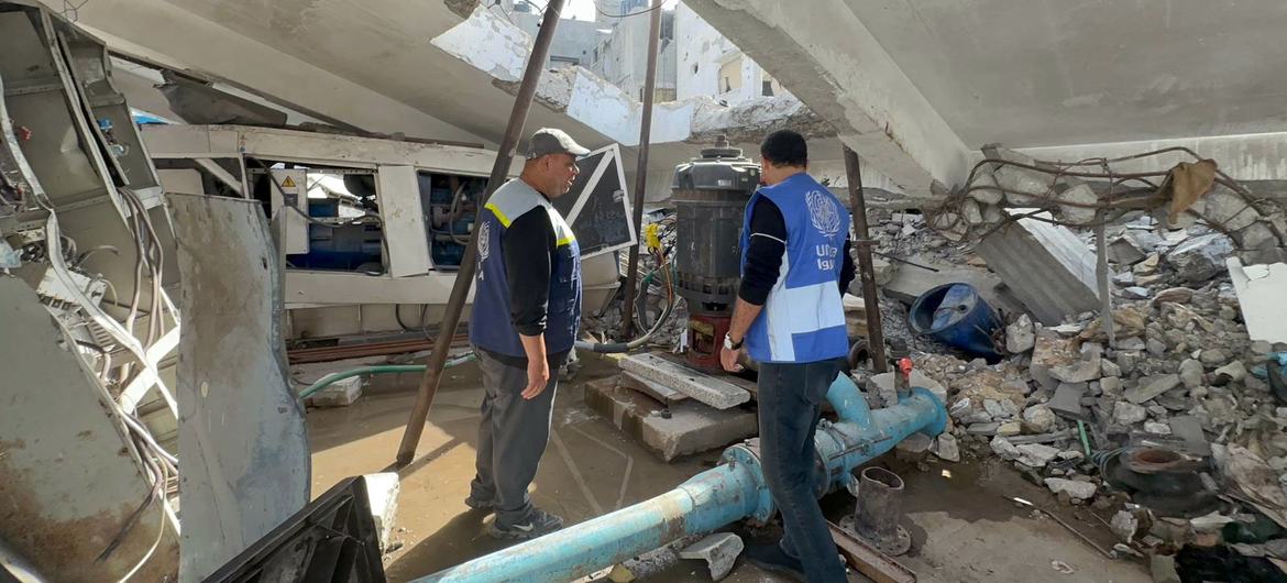 An UNRWA member of staff inspects destroyed infrastructure. An UNRWA member of staff inspects destroyed infrastructure.