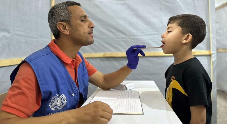 Un employé de l'UNRWA soigne un jeune garçon à Gaza.