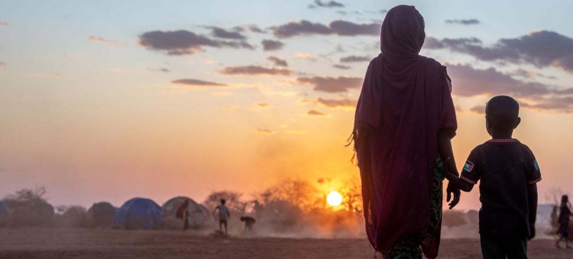 A mother and a child walk together in a camp for displaced people in Ethiopia.