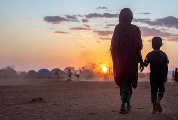 A mother and a child walk together in a camp for displaced people in Ethiopia.