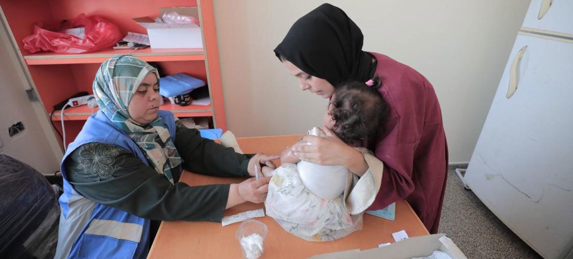 A woman attends a health clinic with a baby in the Gaza Strip. (file)