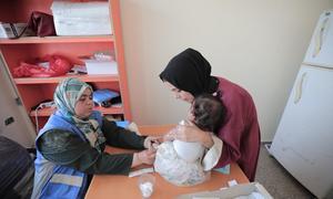 A woman attends a health clinic with a baby in the Gaza Strip. (file)