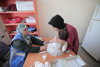 A woman attends a health clinic with a baby in the Gaza Strip. (file)