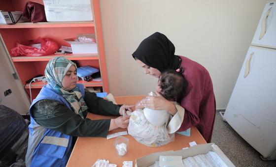 A woman attends a health clinic with a baby in the Gaza Strip. (file)