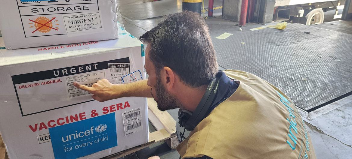 A UNICEF staff member checks a polio vaccination shipment destined for Gaza.