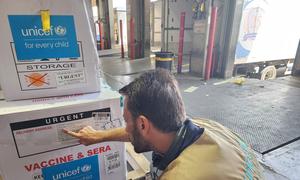 A UNICEF staff member checks a polio vaccination shipment destined for Gaza.