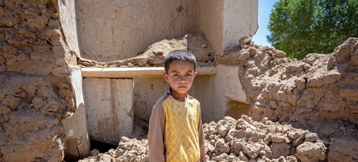  9-year-old Farzan in the ruins of his house in Ghor province, western Afghanistan (May 2024)