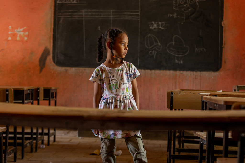 6-year-old Fatima, from Khartoum stands in an empty classroom at the UNICEF supported safe learning space in Kassala state, Sudan