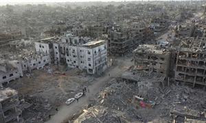 The Kamal Adwan hospital (left) in northern Gaza is surrounded by destruction.