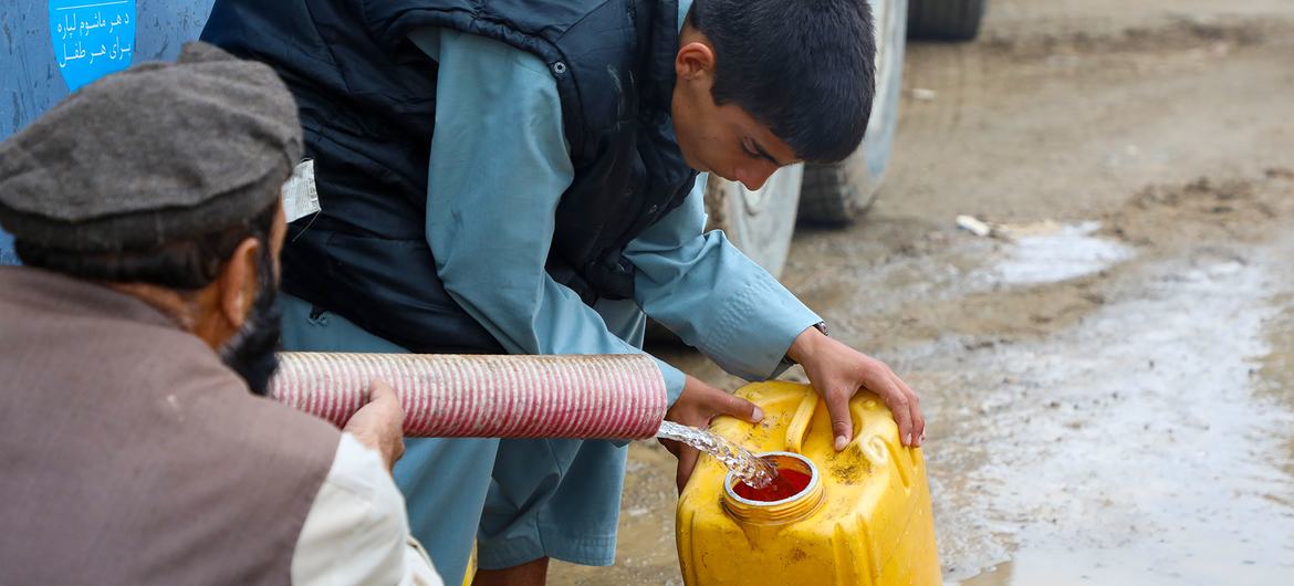 People in central Afghanistan collect trucked water after their homes were washed away by the floods.